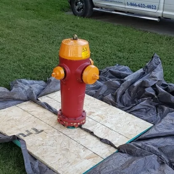 Sandblasting fire hydrant before