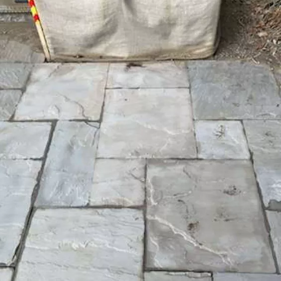 Sandblasting patio stones before